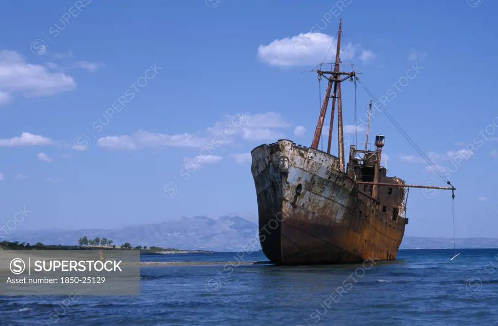 Greece, Peloponnese, Shipwreck In Shallow Water Next To Sandy Beach