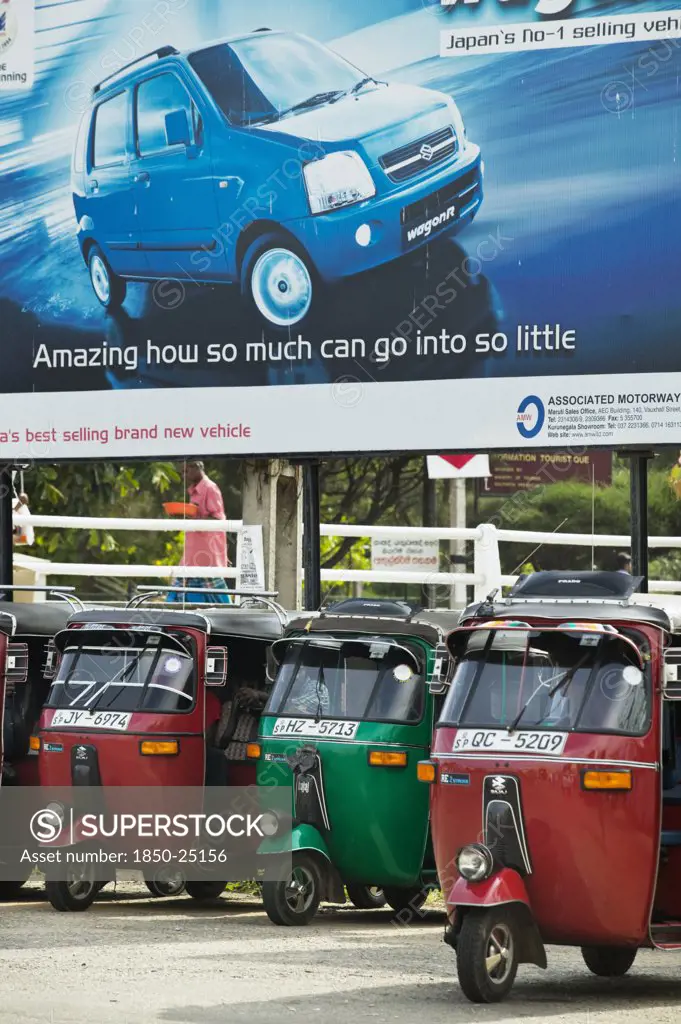 Sri Lanka, Transport, Tuk Tuks Parked Underneath Advertising Billboard For Suzuki Wagonr.