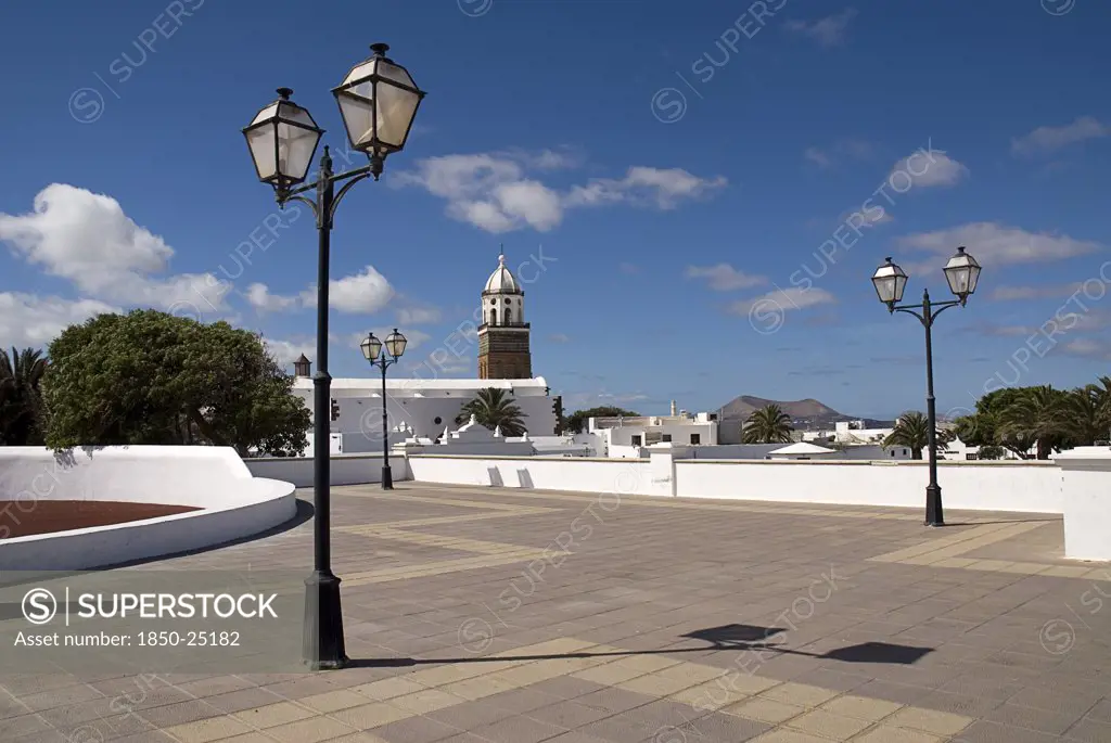 Spain, Canary  Islands, Lanzarote, 'Teguise, The Former Capital Of The Island.  Large Open Square Known As Parque Le Mareta With Tower Of Church Of Nuestra Senora De GuadalupeS And Street Lamps.'