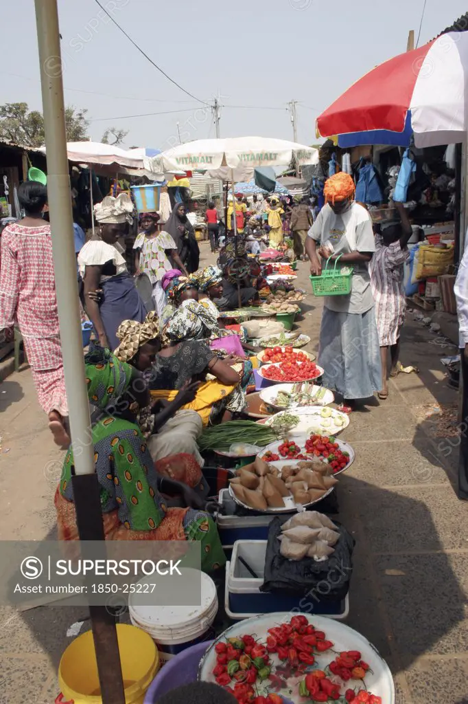 Gambia, Western Gambia, Serekunda, 'Bakau Market, Atlantic Road.  Busy Market Scene With Women Selling Fruit And Vegetables. '
