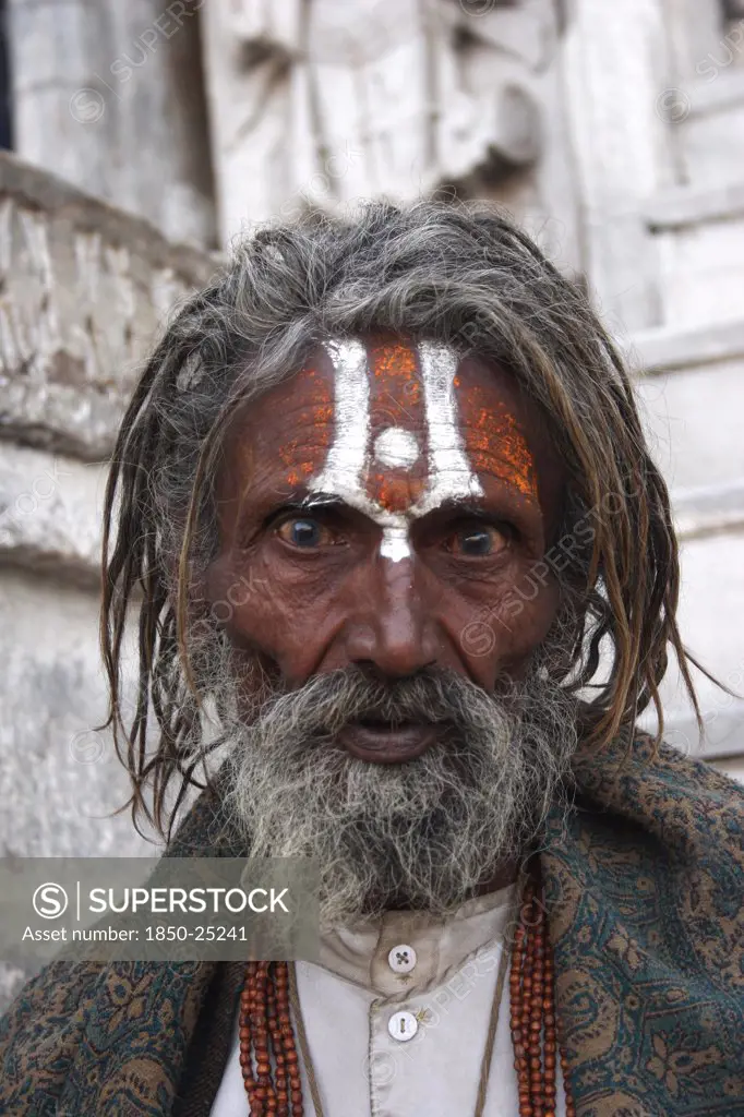 India, Rajasthan, Udaipur, 'Head And Shoulders Portrait Of Elderly Male Hindu Beggar In Front Of The Jagdish Temple With Painted Forehead And Wide Eyed, Fixed Stare.'