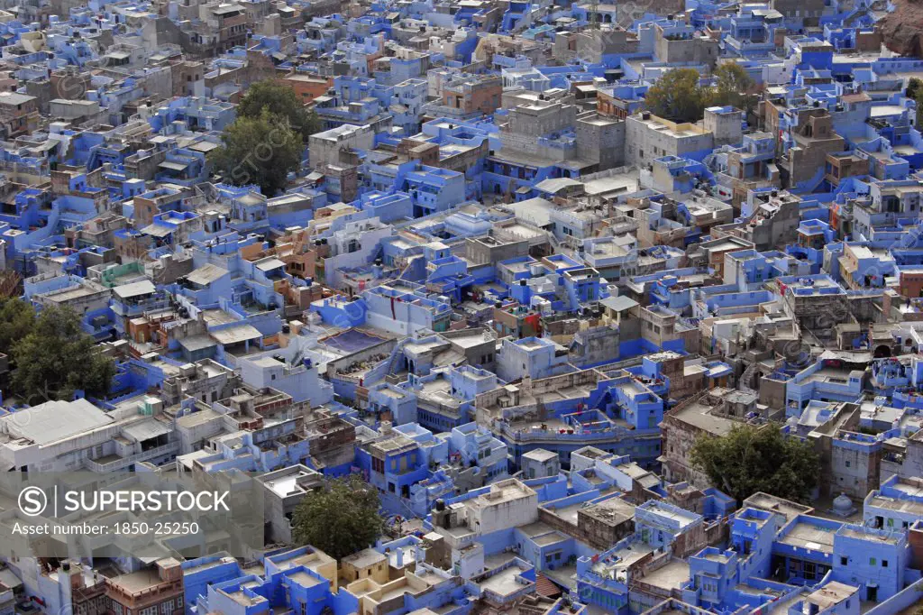 India, Rajasthan, Jodhpur, Elevated View Across Flat Rooftops Of Blue Painted Houses Of The Brahmin Neighbourhood From Meherangarh Fort.