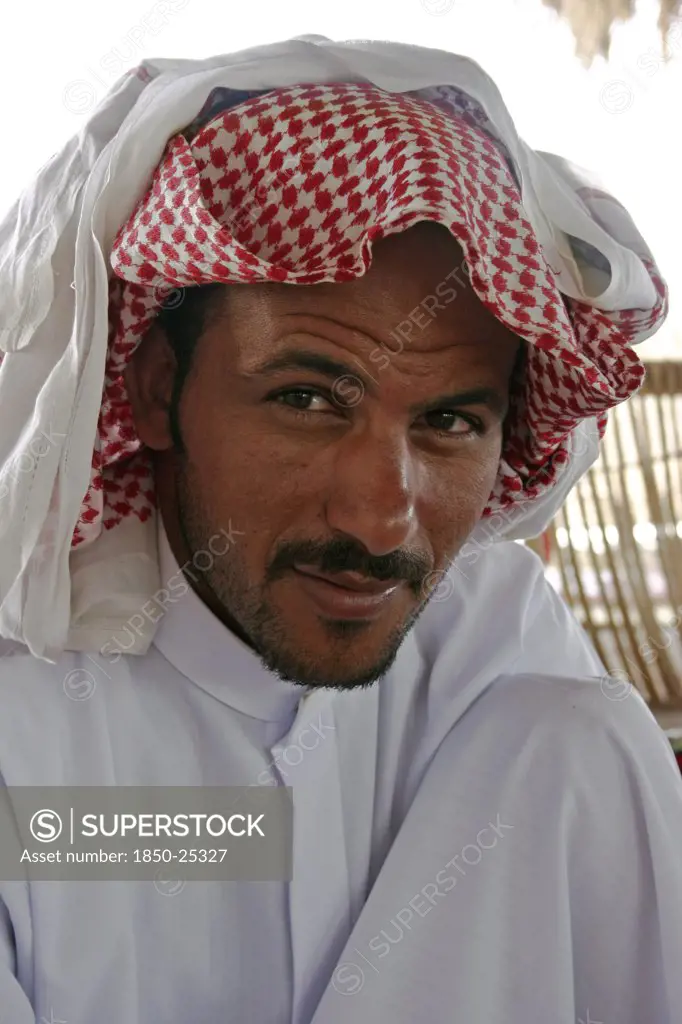 Egypt, Sinai Desert, Ras El Satan, 'Portrait Of A Bedouin Man With Short, Trimmed Beard And Moustache, Wearing Traditional Arabic Dress Of Keffiyeh And Jalabiya.'
