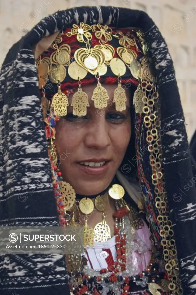 Tunisia, Sahara, Tozeur, 'Head And Shoulders Portrait Of Tunisian Bride Wearing Traditional Dress, Gold Jewelry And Decorated Head Dress In Preparation For Her Wedding Held On The Edge Of The Sahara Desert.'