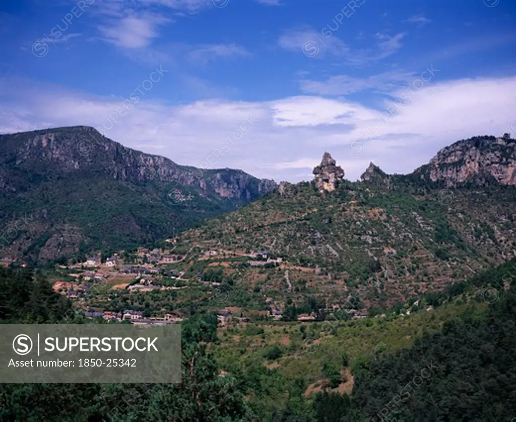 France, Midi-Pyrenees, Aveyron, View Across Gorge De La Jonte Junction With The Tarn Gorge At Le Rozier Village Set On Terraced Hillside Topped With Pinnacles Of Eroded Rock.