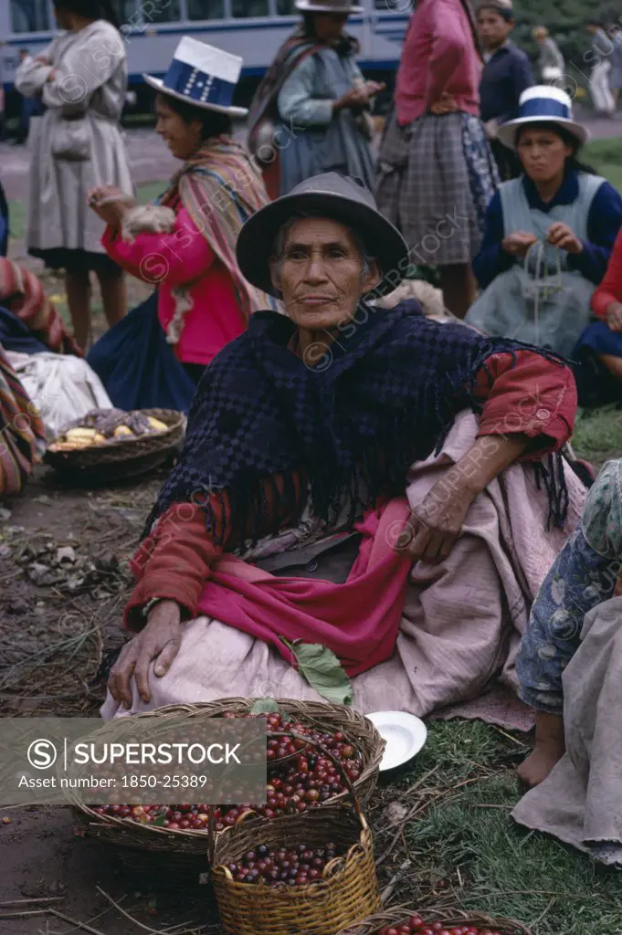 Peru, Cusco, Woman Selling Cherries From A Basket At The Railhead. Near Cusco