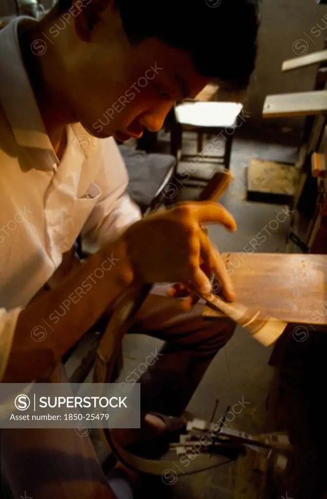 China, Jiangsu Province, Suzhou, Man Hand Cutting With Saw Sandalwood Fans