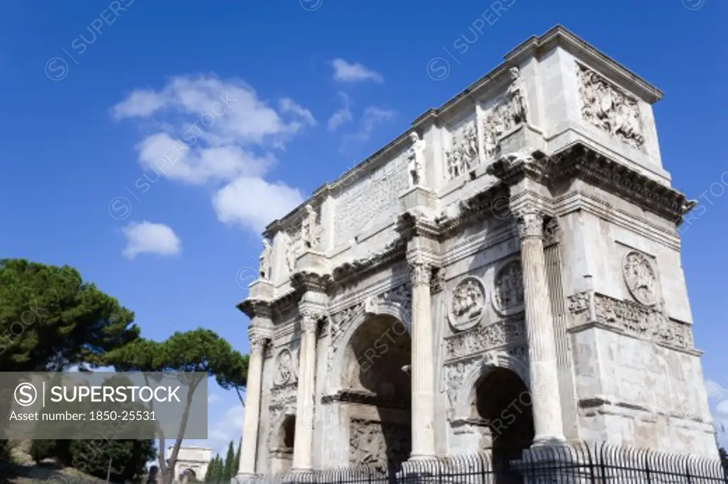 Italy, Lazio, Rome, The South Face Of The Triumphal Arch Of Constantine With The Arch Of Titus In The Background