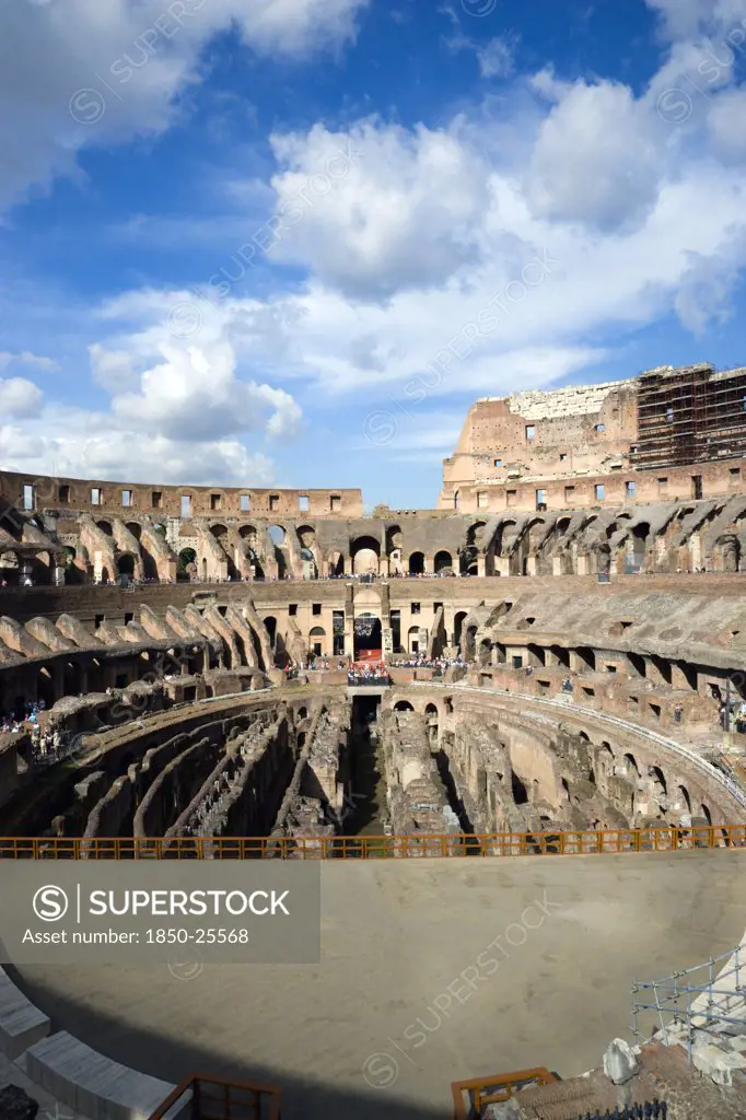 Italy, Lazio, Rome, The Colosseum Amphitheatre Interior With Tourists Built By Emperor Vespasian In Ad 80 In The Grounds Of Domus Aurea The Home Of Emperor Nero Showing The Restored Sections In The Foreground
