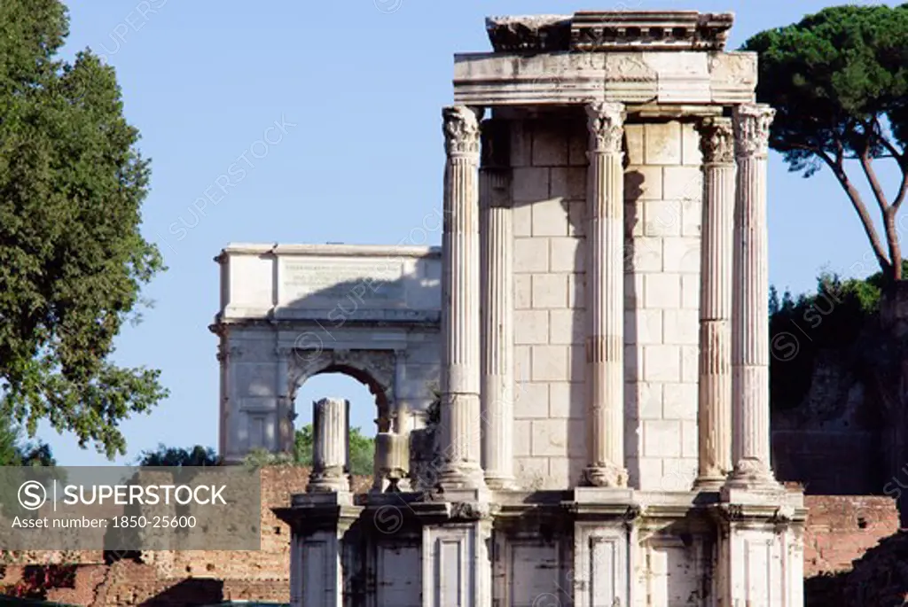 Italy, Lazio, Rome, The Temple Of Vesta In The Forum With The Arch Of Titus In The Distance