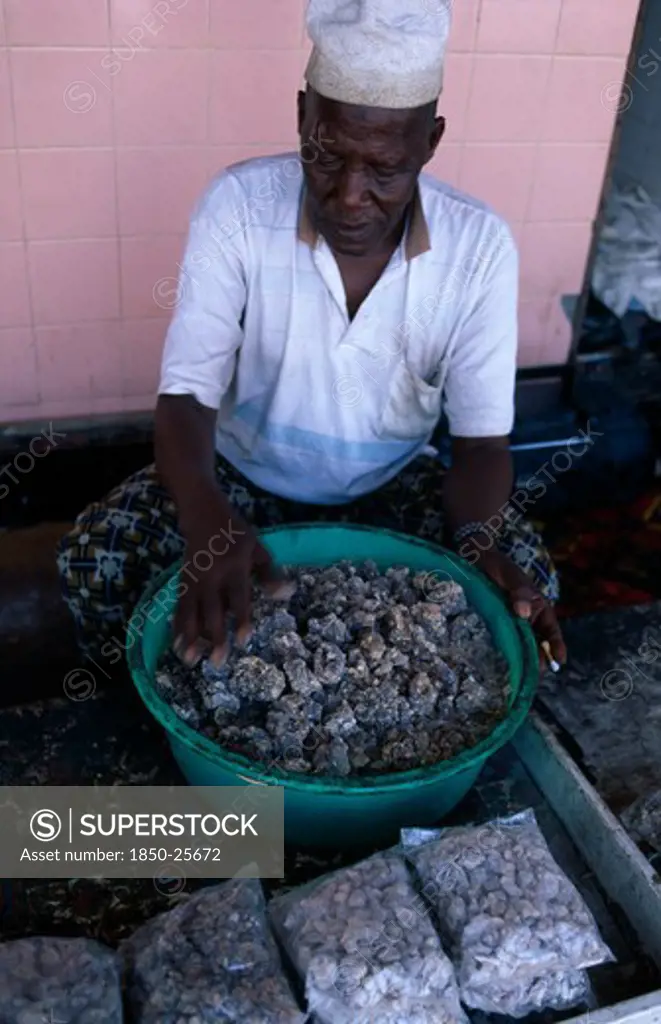 Oman, Salalah, Trader Sorting Second Grade Frankincense.