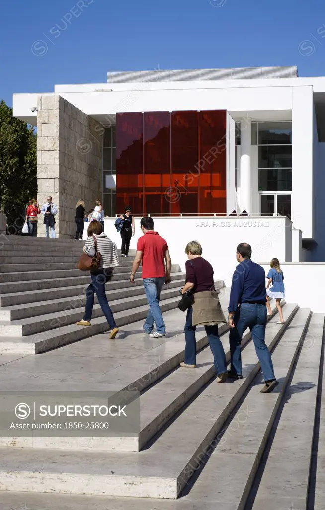 Italy, Lazio, Rome, The Steps With Sightseers Leading To The Building Hosuing The Ara Pacis Or Altar Of Peace Built By Emperor Augustus To Celebrate Peace In The Mediteranean. The Red Prespex Cube Is Part Of A Valentino Fashion Exhibition At The Museum