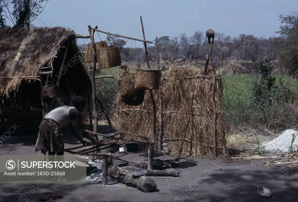 Malawi, Tribal People, Yau Tribe, Yau Village With Man Cooking Over An Open Fire