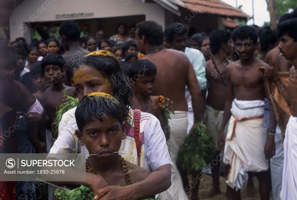 Sri Lanka, Religion, Hinduism, 'Punnaccolai Festival. Tamil Oracle Named Sothimalar With Her Arms Wrapped Around Her Son, Both With Ritual Trident Piercings Inserted Through Cheeks'