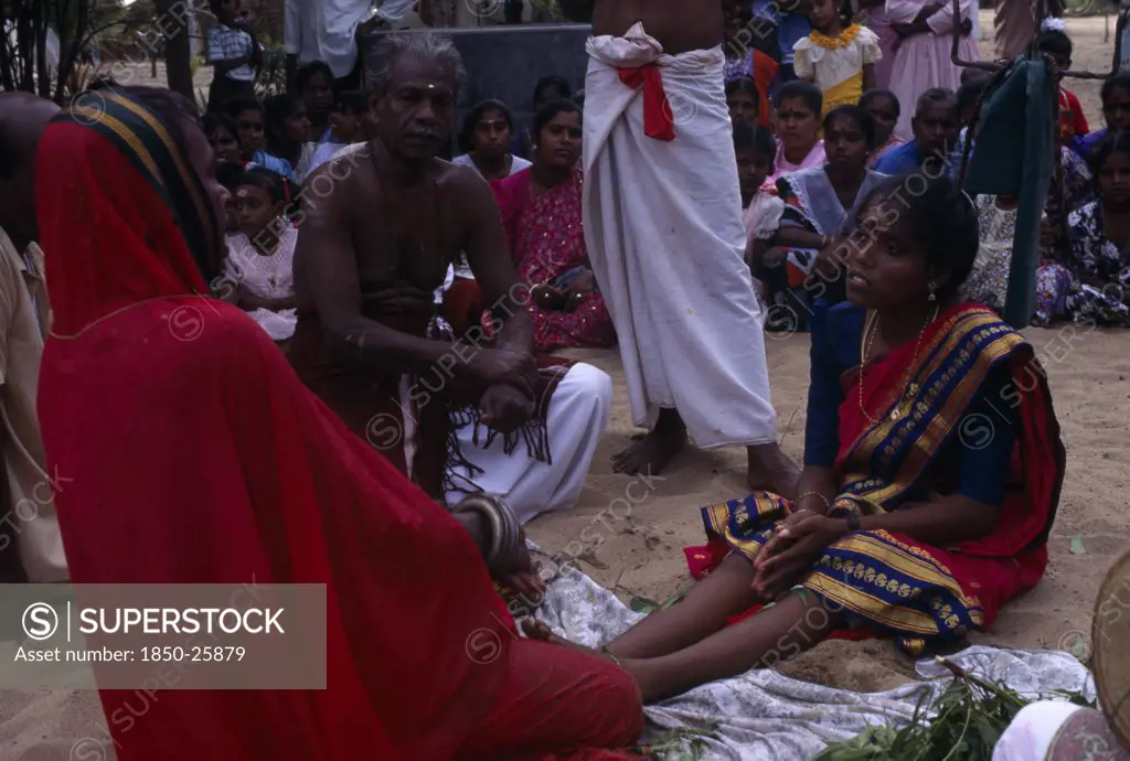 Sri Lanka, Religion, Hinduism, Punnaccolai Festival. Hindu Tamil Priest Wearing A Red Robe Performing A Curing / Healing Puja On A Woman