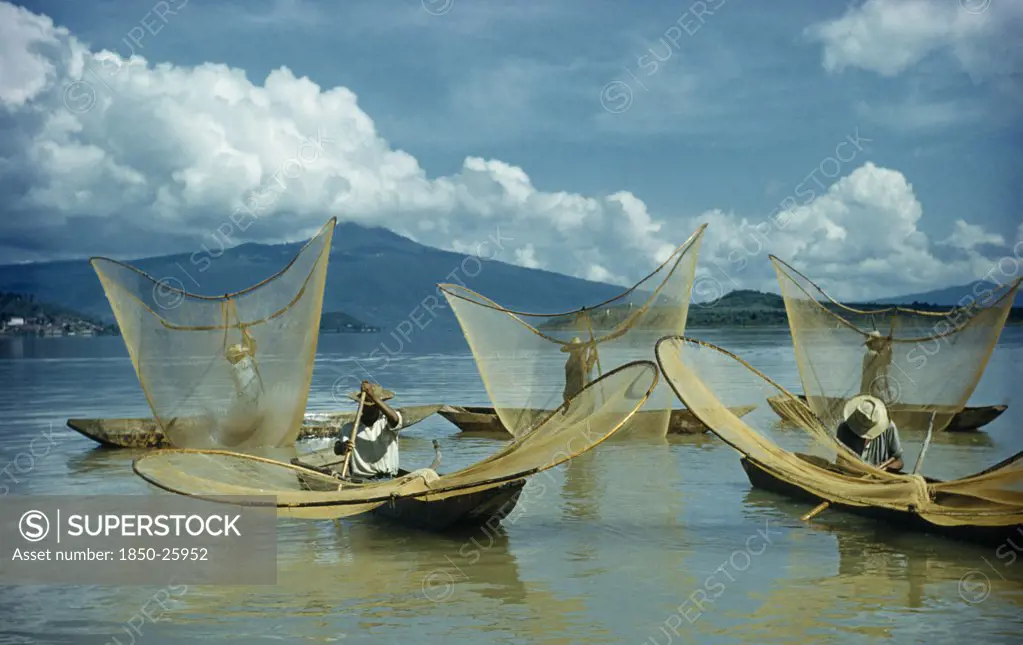Mexico, Michoacan, Patzcuaro, Fishermen Butterfly Net Fishing From Canoes On Lake Patzcuaro