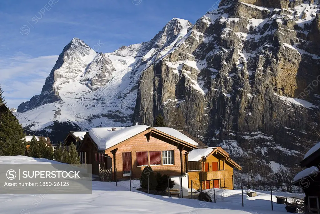 Switzerland, Bernese Oberland, Murren, Snow Covered Houses In Murren With Eiger Mountain Behind
