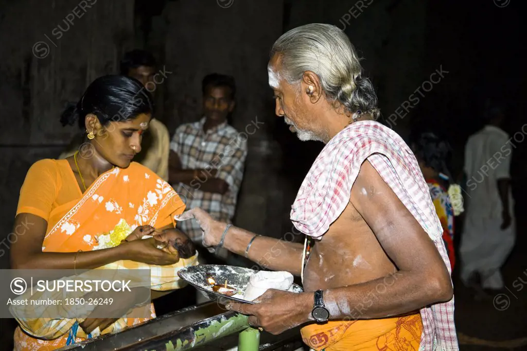India, Tamil Nadu, Madurai, Brahmin Blessing A Baby Held In His Mothers Arms At Meenakshi Temple