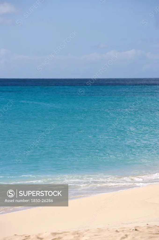 West Indies, St Vincent And The Grenadines, Canouan Island, South Glossy Beach In Glossy Bay With Waves Breaking On The Shoreline Of The Turqoise Sea.