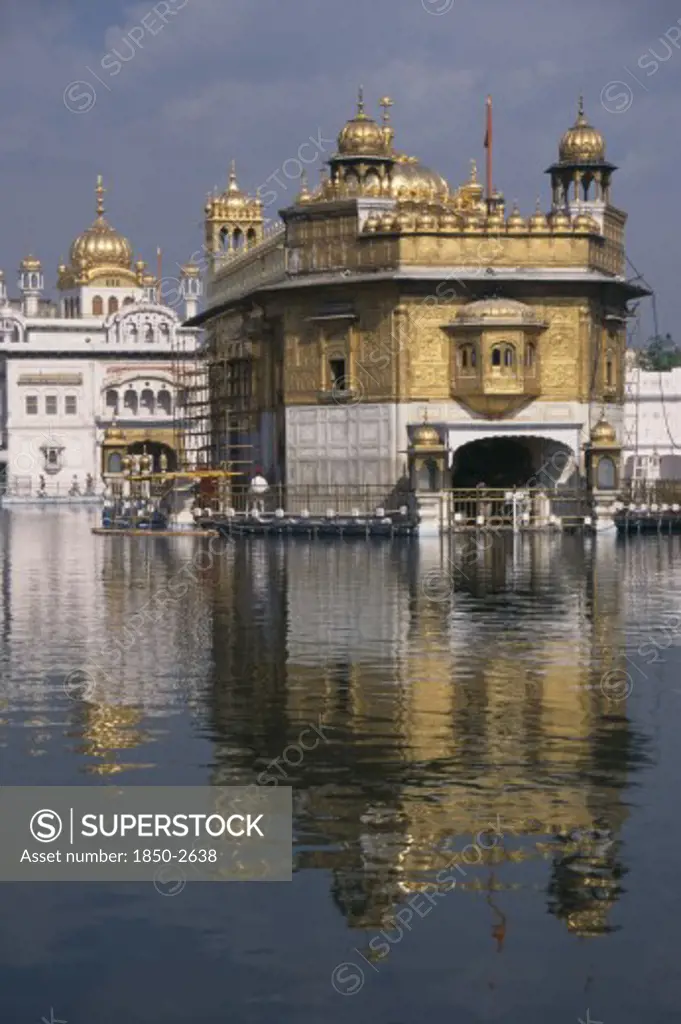 India, Punjab, Amritsar, Golden Temple Reflected In Surrounding Pool.