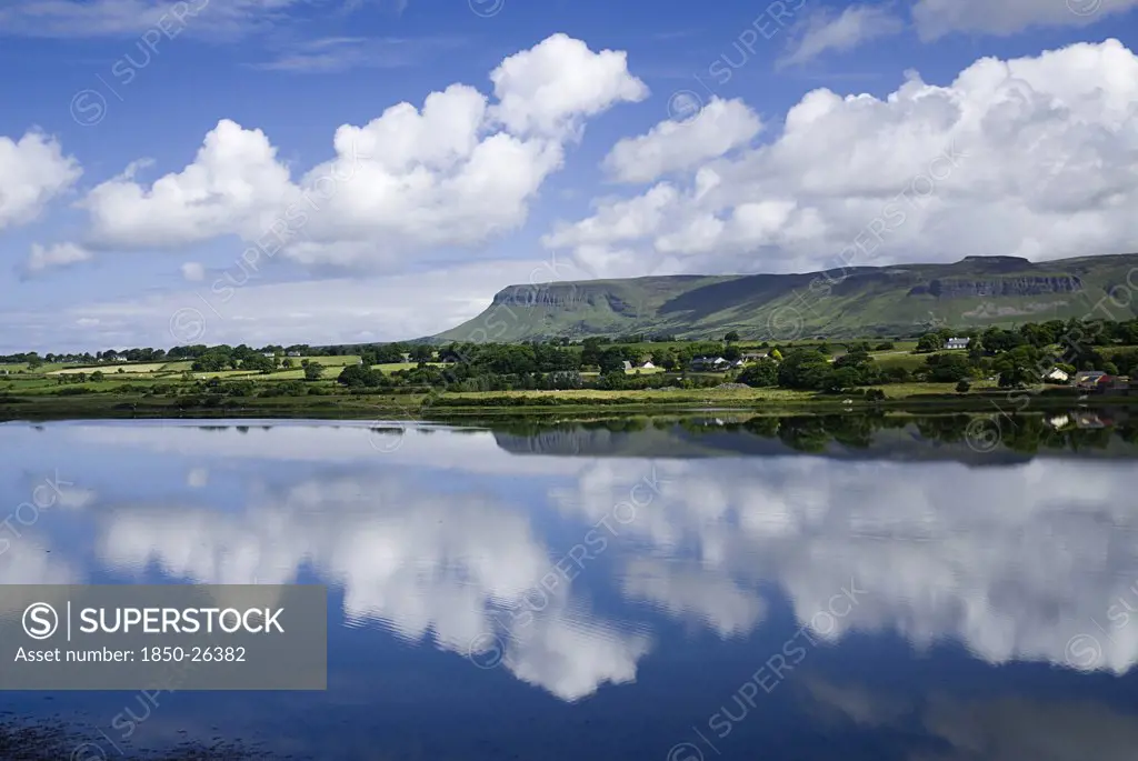 Ireland, Sligo, Sligo , Sligo Bay And Ben Bulben From Outskirts Of The Town.  Blue Sky And White Cloudscape Reflected In Water.
