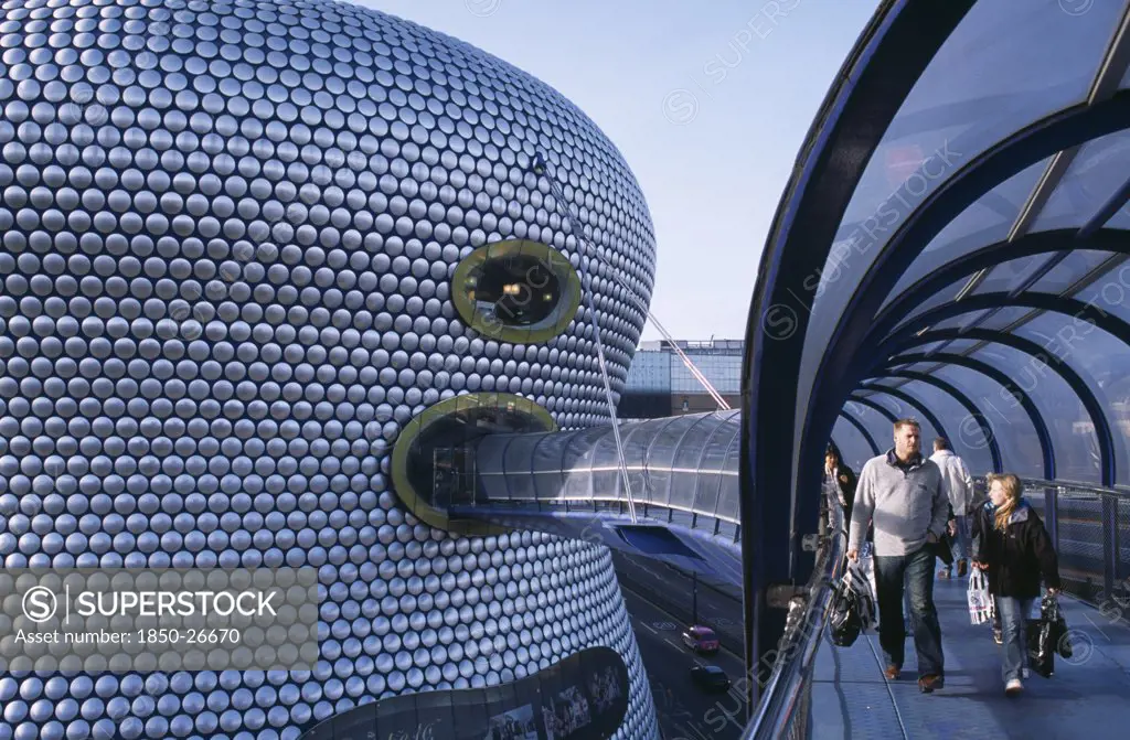 England, West Midlands, Birmingham, 'Selfridges Store At The Bullring Shopping Centre. Exterior Detail Of The Spun Aluminium Discs And Shoppers Walking Through The Parametric Bridge, A Curved Covered Footbridge Suspended Over The Street.'