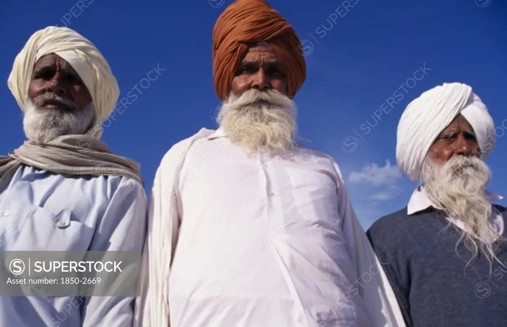 India, Punjab , Amritsar, 'Three Elderly Sikh Men, Head And Shoulders Portrait From Low Angle Looking Up'
