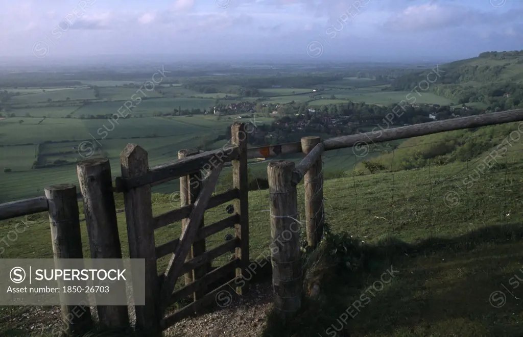 England, West Sussex, Devils Dyke, Stile Gate On DevilS Dyke With View Over Lush Green South Downs Landscape