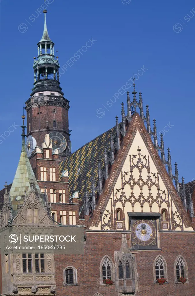 Poland, Wroclaw, Wroclaw Town Hall Dating From The Fourteenth Century.  Part View Of Exterior With Decorative Gable And Brickwork  Astronomical Clock And Clock Tower.