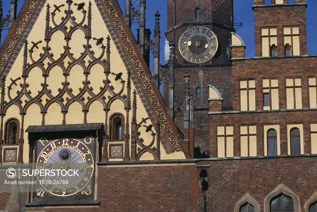 Poland, Wroclaw, Wroclaw Town Hall Dating From The Fourteenth Century.  Part View Of Exterior With Decorative Gable  Brickwork And Astronomical Clock With Clock Tower Behind.