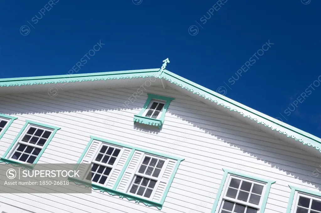 West Indies, Grenada, Carriacou, White Timber Clapperboard Front Of A House With Turquoise Green Painted Details