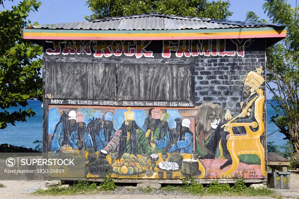West Indies, Grenada, Carriacou, Colourful Rastafarian Food Hut Called Jam Rock Cafe On The Beach In Hillsborough Decorated With A Rastafarian Last Supper And Emperor Haile Selassie Painted On It And The Words May The Lord Of Lords Bless And Keep Us Always