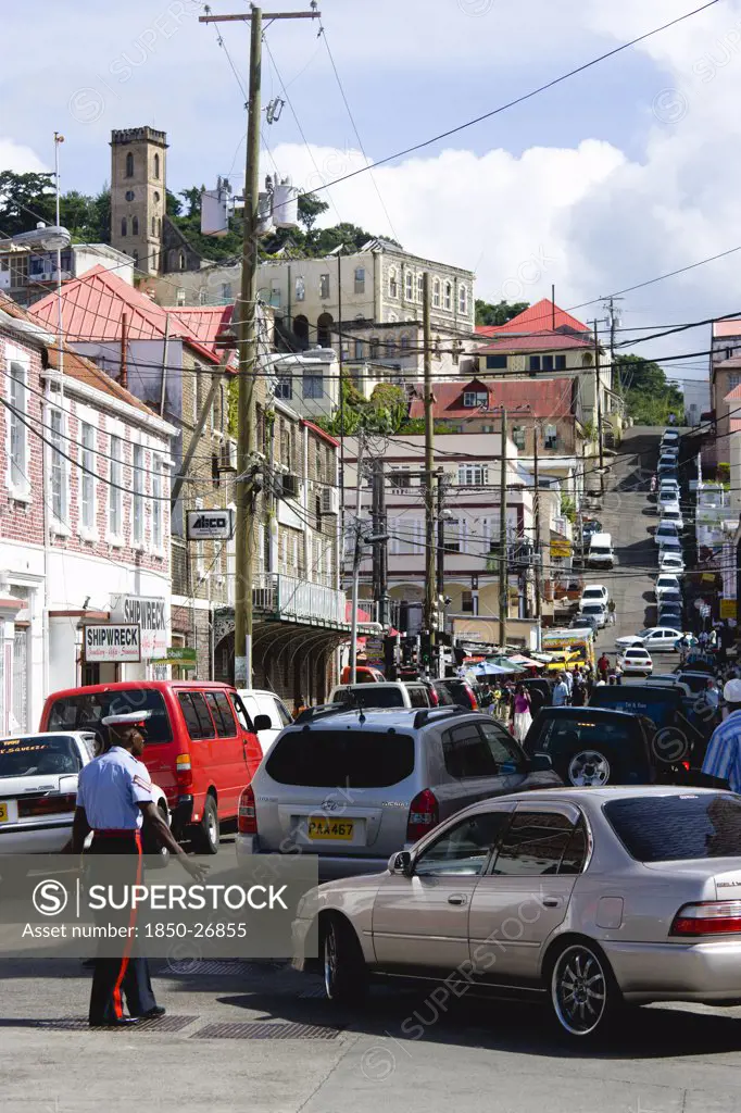 West Indies, Grenada, St George, Male Corporal Of The Royal Grenadian Police Force Directs Traffic In Busy Market Street In The Capital City Of St George'S