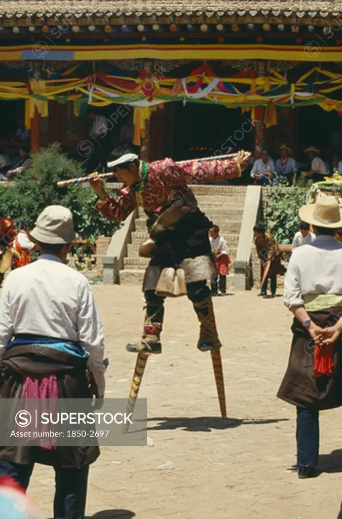 China, Qinghai, Tongren, Tibetan Stilt Dancer At Festival