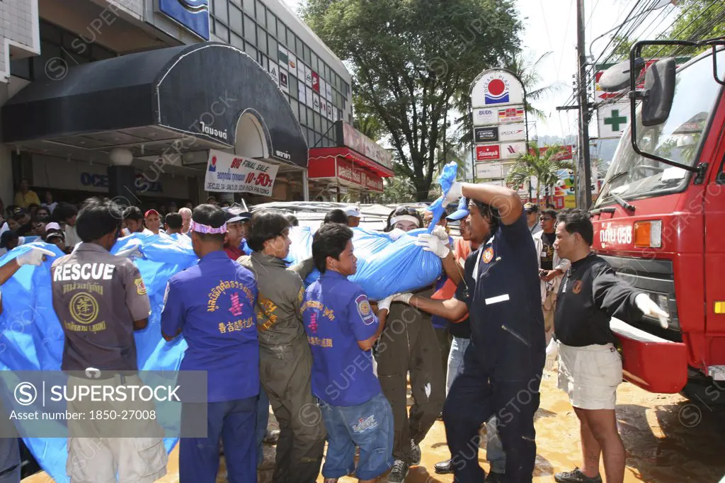 Thailand, Phang Nga District, Phuket, 'Tsunami Carnage The Day After. Bodies Of Foreign Tourists Are Brought Out Of A Flooded Supermarket Which Was In The Basement Along Patong Beach Road By Rescue Workers. Patong Is The Busiest Part Of Phuket With Hotels, Bars, And Shops In A Very Tightly Condensed Area, And Being Peak Season Had Thousands Of Tourists In The Area.  On The 27Th Dec'
