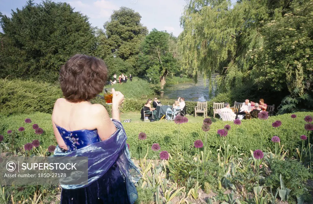 England, East Sussex, Glyndebourne, Opera Attendees Enjoying Picnics In The Gardens During Interval.