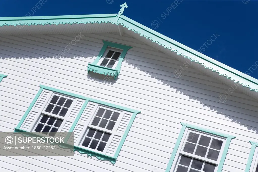 West Indies, Grenada, Carriacou, Hillsborough Turqoise And White Wooden Clapperboard House Detail Against A Clear Blue Sky.