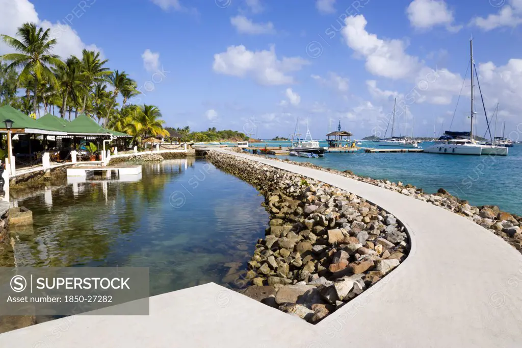 West Indies, St Vincent & The Grenadines, Union Island, The Walkway And Shark Pool Beside The Bar And Restaurant Of The Anchorage Yacht Club In Clifton Harbour.