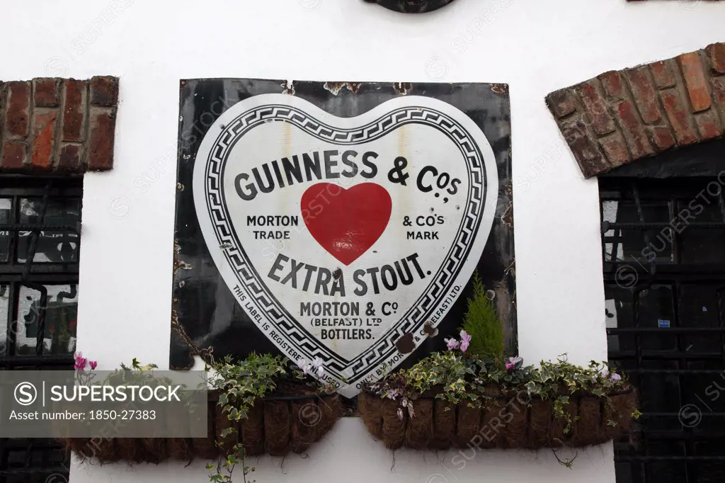 Ireland, North, Belfast, 'Cathedral Quarter, Commerical Court, Old Metal Red Heart Belfast Bottled Guinness Sign Decorating The Exterior Of The Duke Of York Public House'