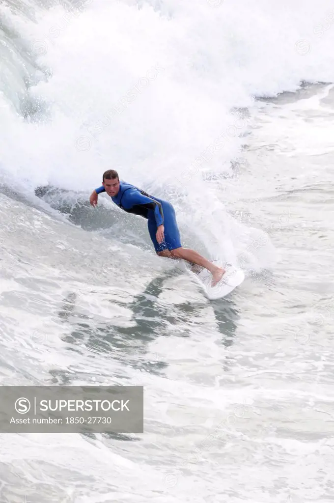 Usa, California, Los Angeles, Riding The Surf At Huntington Beach