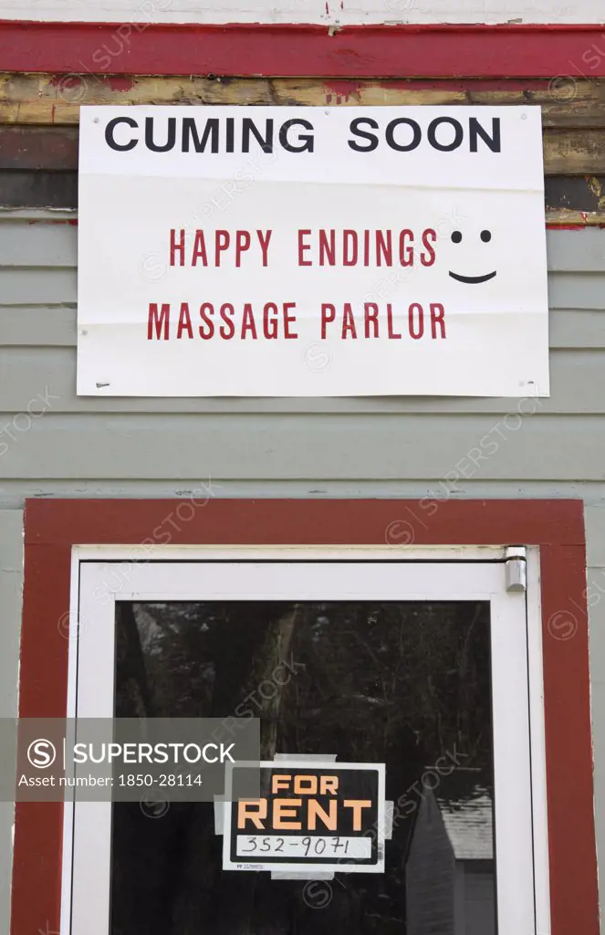 Usa, New Hampshire, Keene, 'Sign On Building, Cuming Soon, Happy Endings Massage Parlor.'