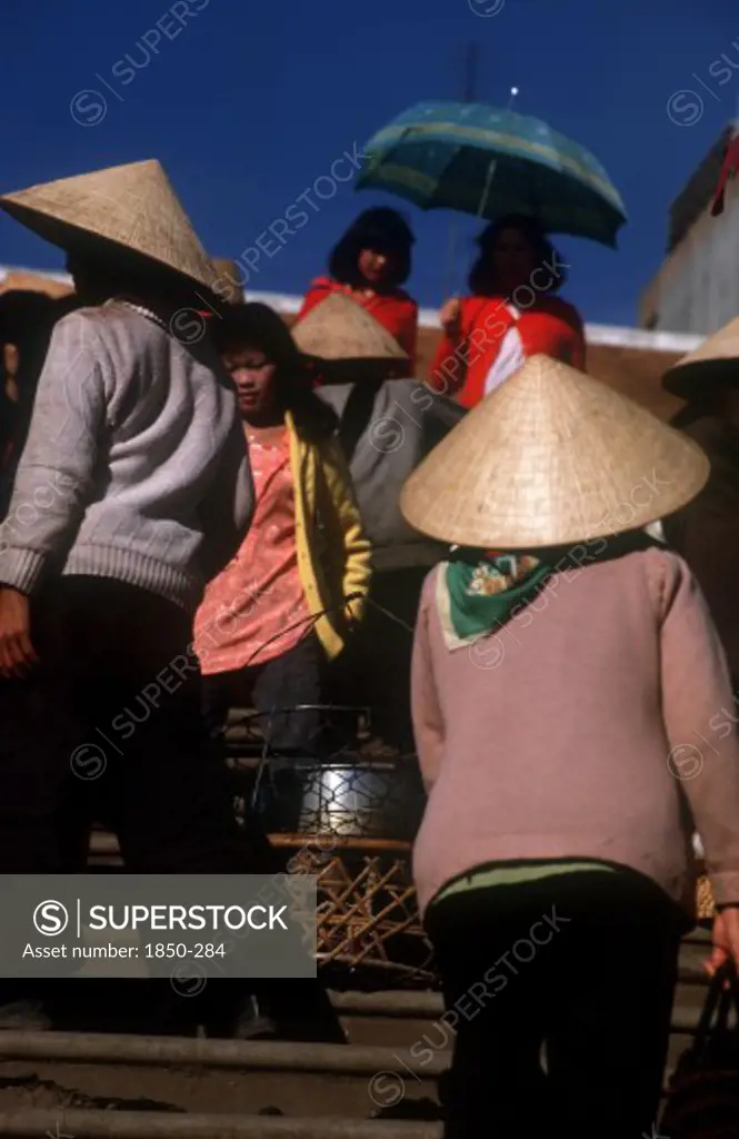Vietnam, Dalat, Women At Dalat Market With Wide Straw Hats And Umbrella.