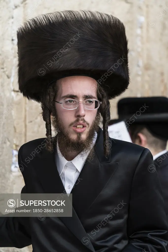 Israel, Jerusalem, Western Wall, A Hasidic Jewish man in his traditional shtreimel or fur hat at the Western Wall of the Temple Mount in the Jewish Quarter of the Old City. Hasidism is a type of ultra-Orthodox Haredic Judaism. The Old City of Jerusalem and its Walls is a UNESCO World Heritage Site.
