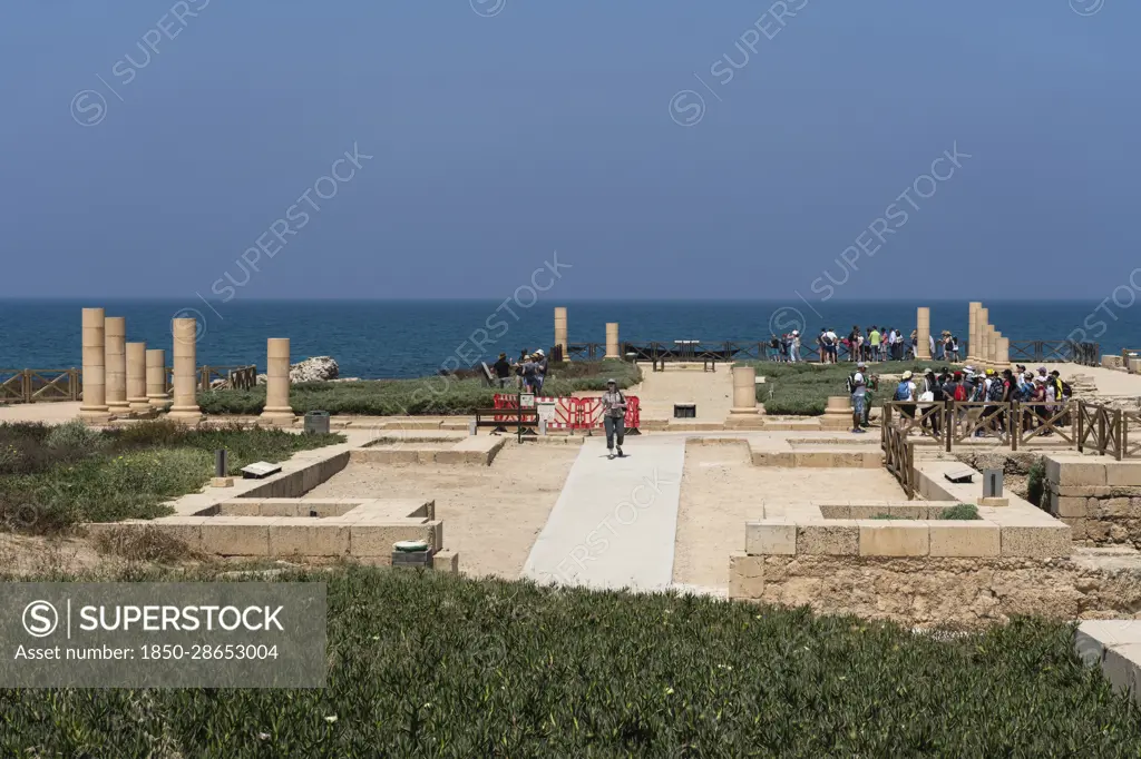 Israel, The ruins of Caesarea Maritima in Caesarea National Park. The city was built as a port on the Mediterranean Sea by Herod the Great between 22 and 15 B.C. In the background is the Orot Rabiin power generating station.