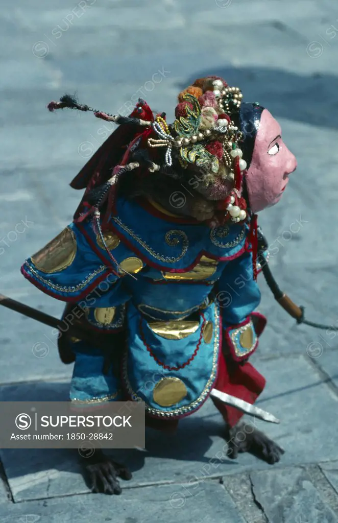 China, Hong Kong, New Territories, Performing Monkey Dressed In Elaborate Costume And Mask.