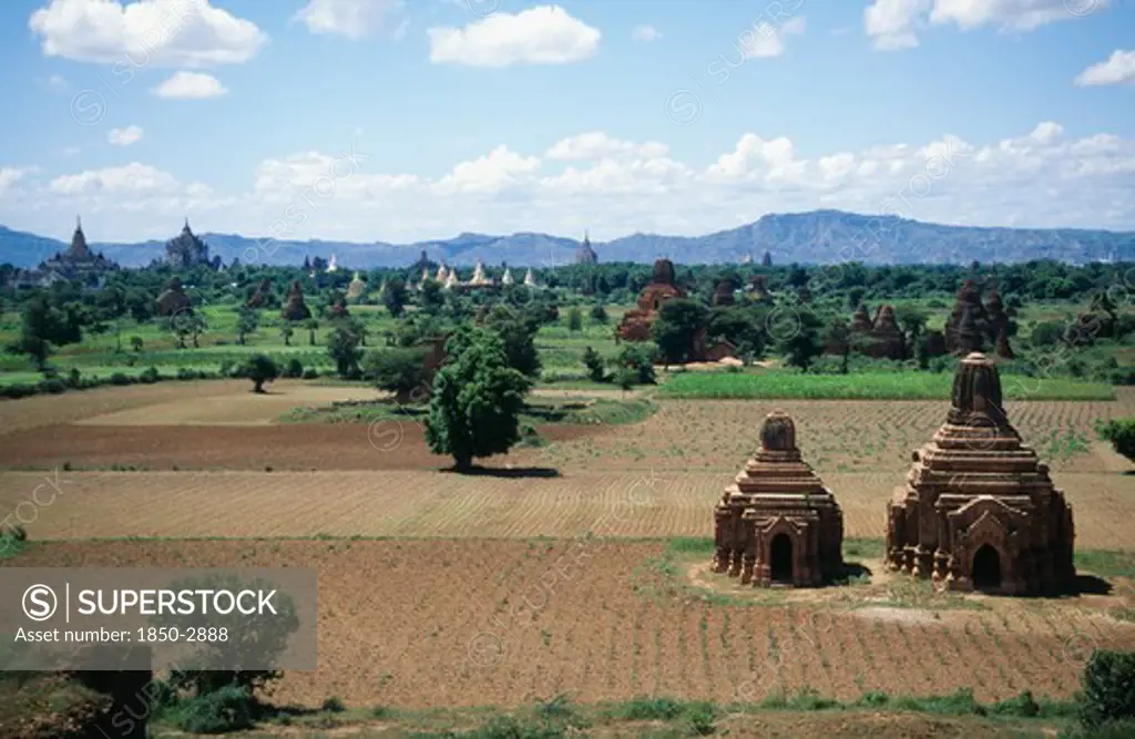 Burma, Pagan, Two Temples In A Field With Others Seen In The Distance