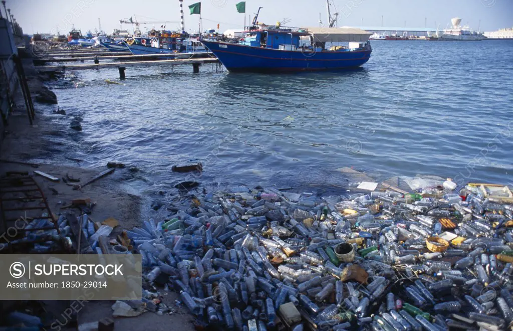 Libya, Tripolitania, Tripoli, Plastic Water Bottles And Other Rubbish Polluting Harbour Area.