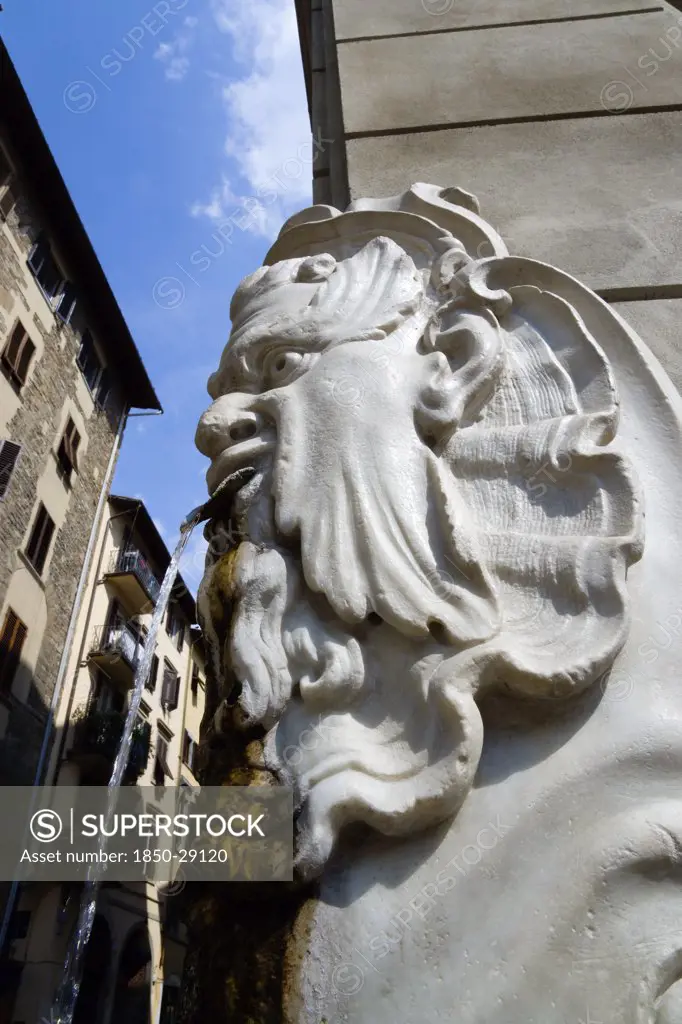 Italy, Tuscany, Florence, Santa Croce District Drinking Water Fountain In The Form Of A Male Head On The Corner Of A Street.
