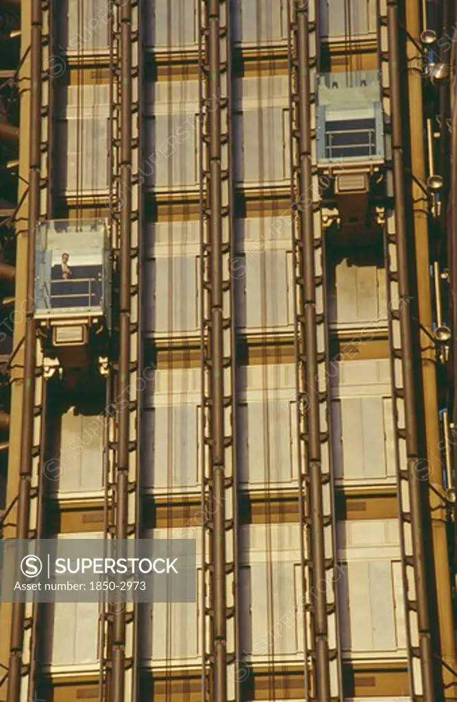 England, London, Lloyds Building Lifts With Passenger On Building Exterior.