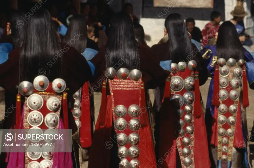 China, Guizhou, Tongren, Tibetan Dancers At A Festival Wearing Traditional Costumes With Silver Ornamental Designs